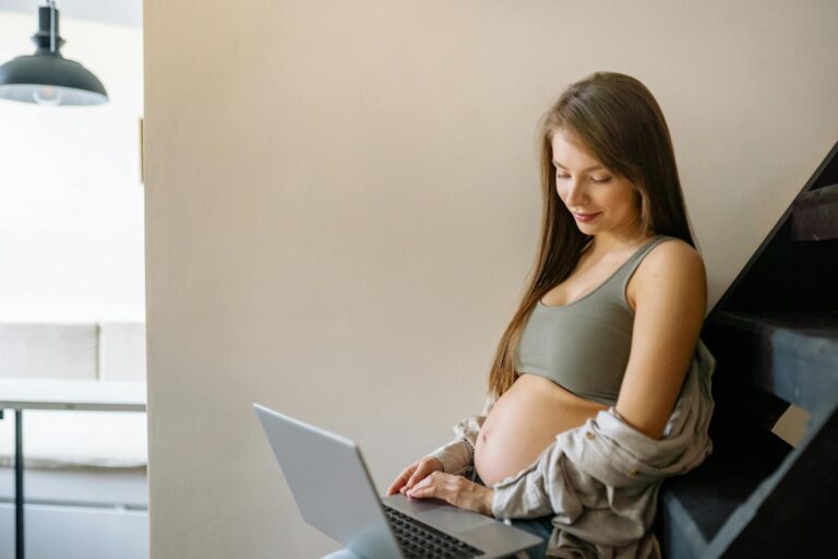 Nachgeburtliche Müttergesundheit im Blick behalten für Körper und Psyche Mutter entspannt mit Baby im Arm im hellen Wohnzimmer nach der Geburt